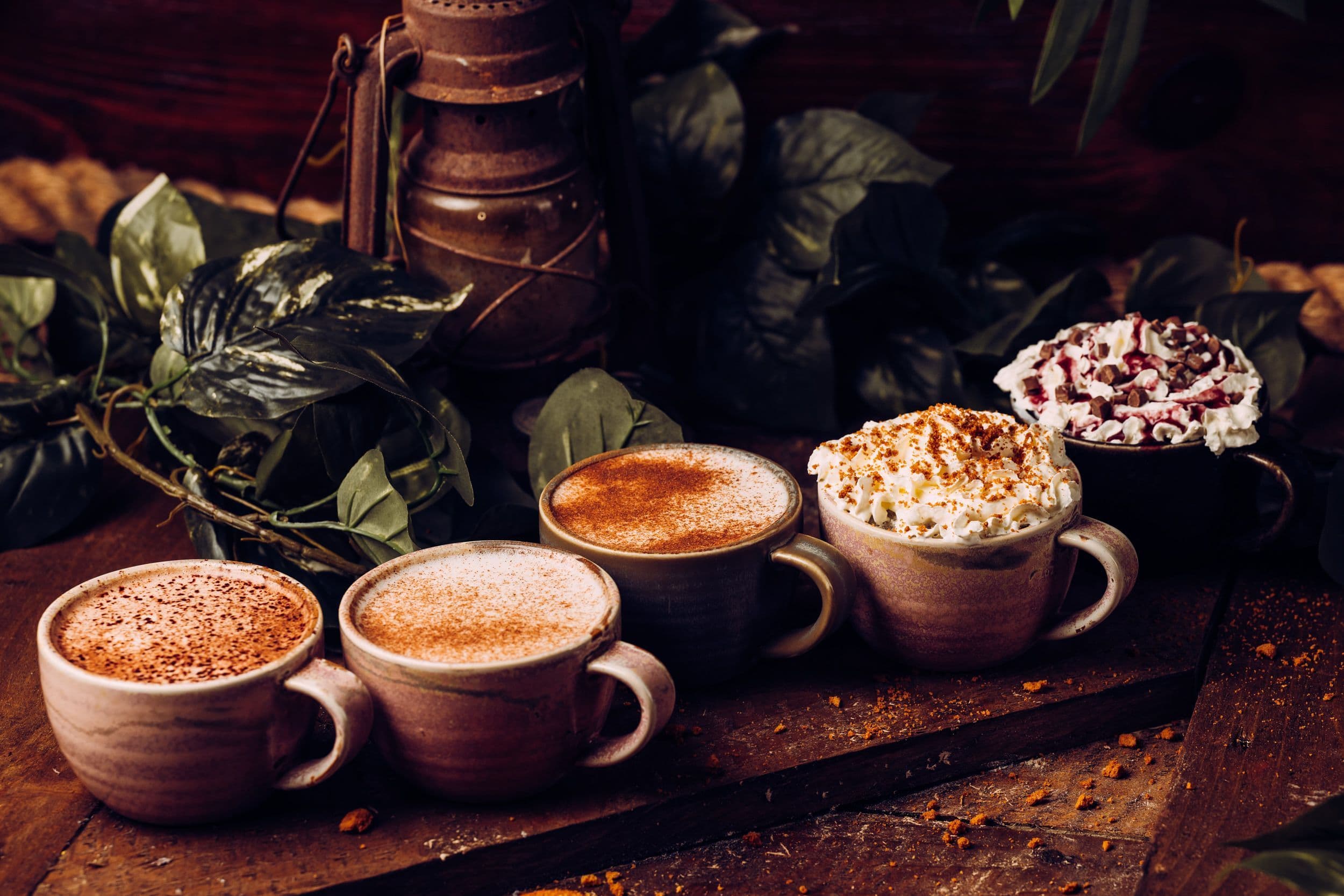 Five festive hot drinks lined up on a table at Treetop Golf.