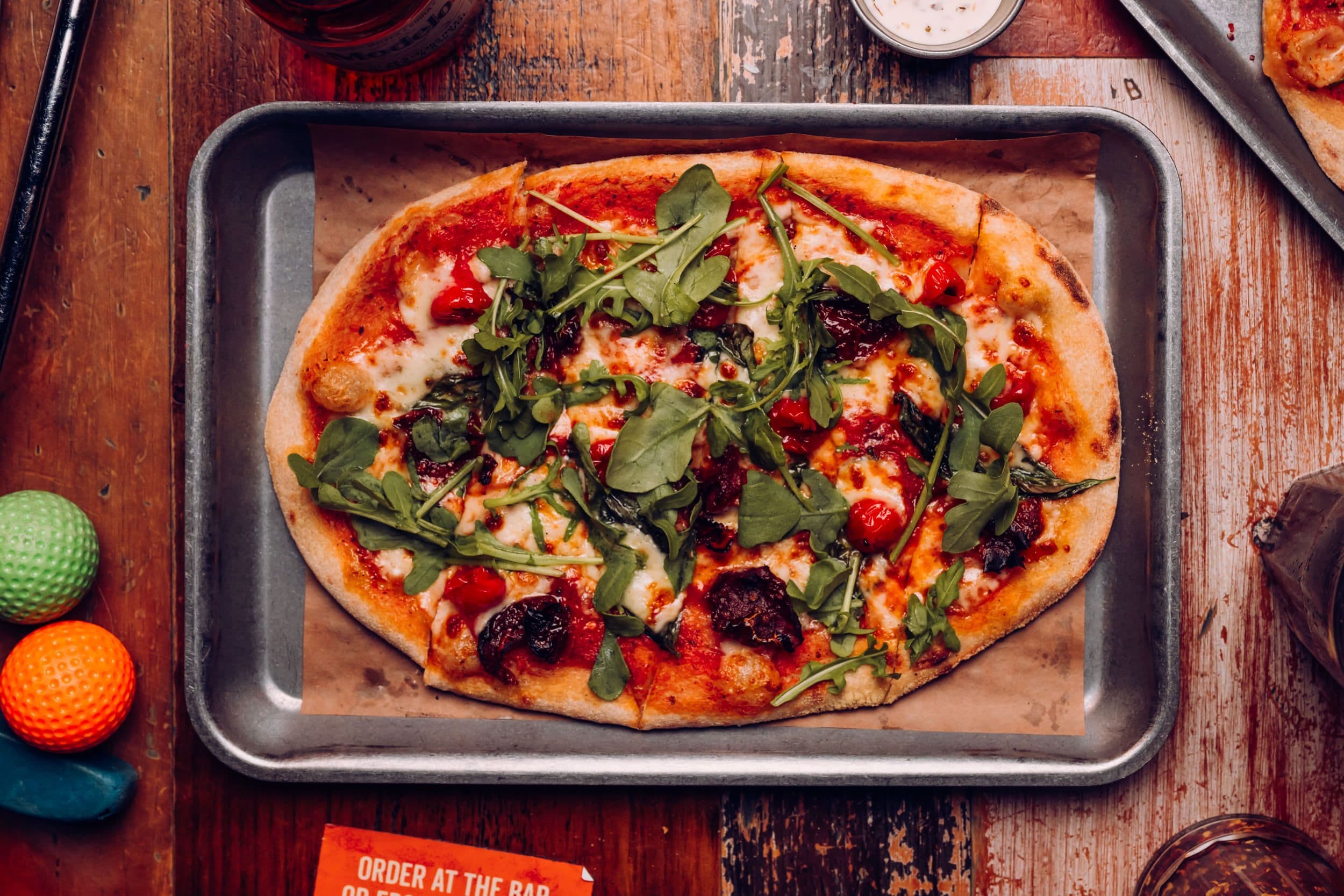 A veggie supreme festive pizza displayed on a table at Treetop Golf.
